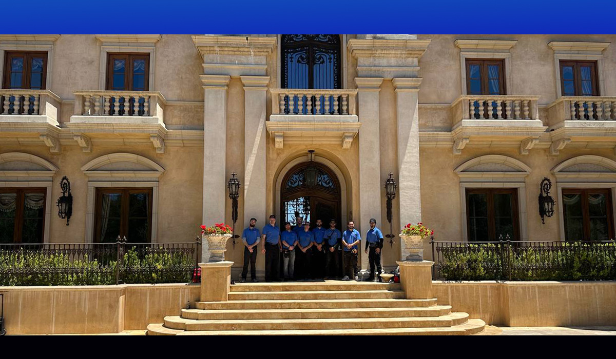 Men standing in front of a large house
