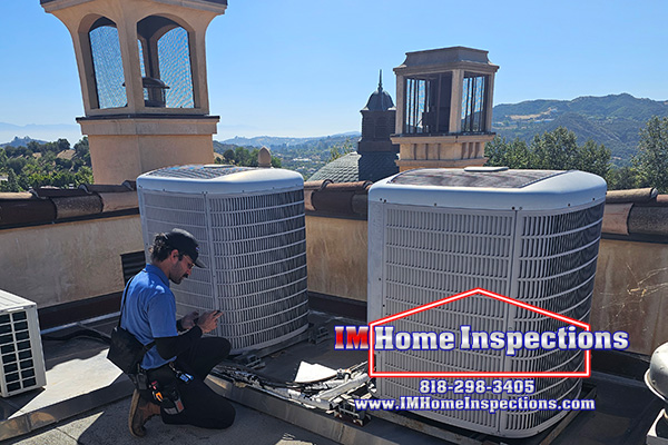 Inspector on the roof inspecting the AC units