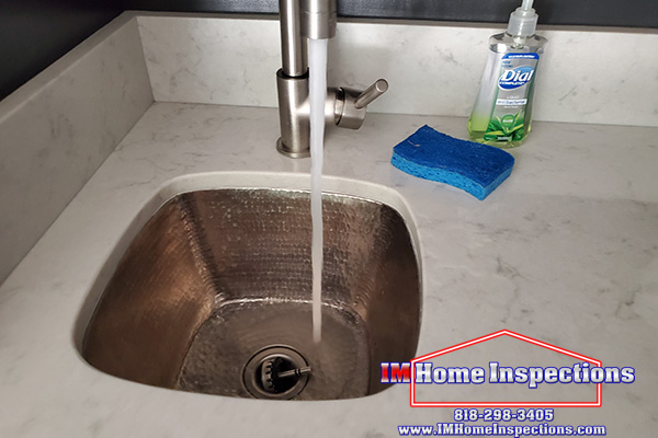 a picture of water running a sink